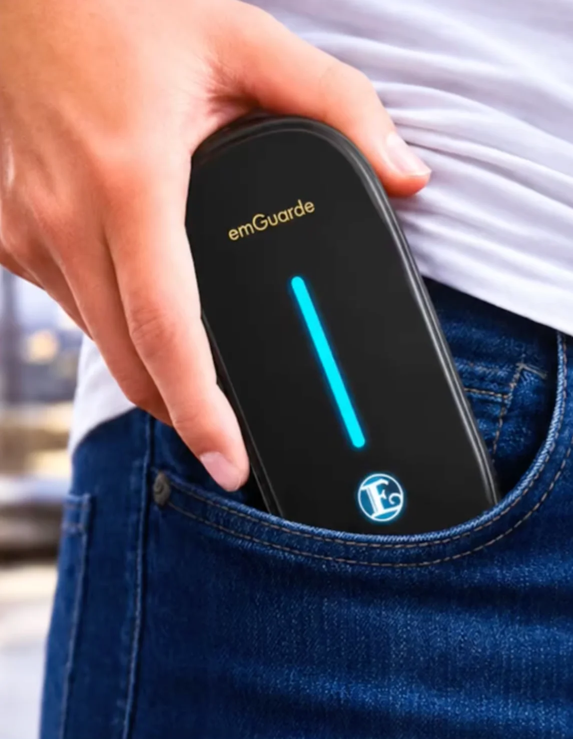 emGuarde Portable being slipped into a jeans pocket, showing its compact travel-friendly size